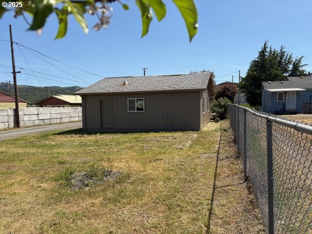view of yard with a fenced backyard and an outdoor structure
