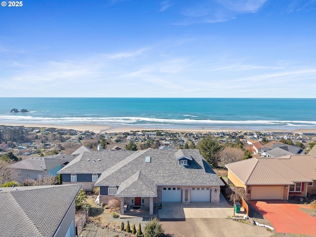 birds eye view of property featuring a water view and a view of the beach