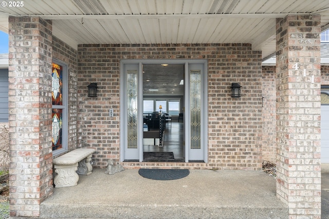 property entrance featuring brick siding