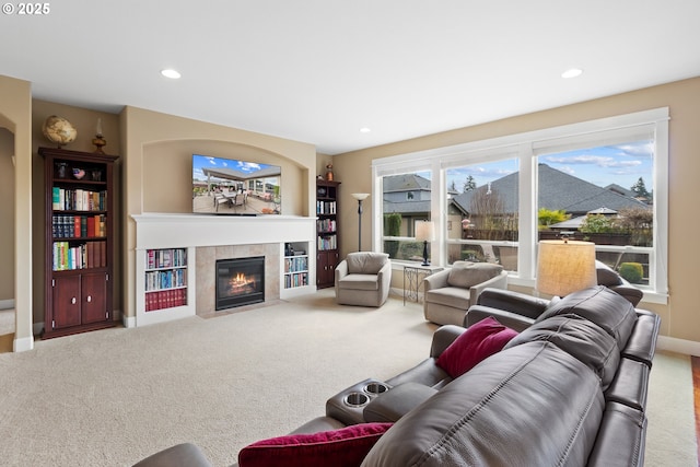 living room with recessed lighting, baseboards, carpet floors, and a tile fireplace