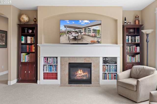 sitting room with carpet flooring, a fireplace, and baseboards