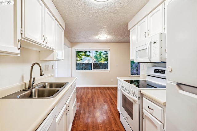 2380 NE Rene Ave, Gresham, OR 97030 - kitchen featuring white appliances, light countertops, white cabinetry, wood finished floors, and a textured ceiling