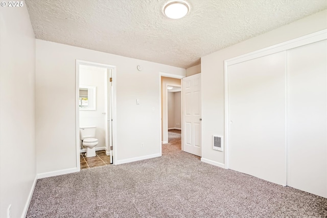 2380 NE Rene Ave, Gresham, OR 97030 - unfurnished bedroom featuring carpet floors, a textured ceiling, a closet, connected bathroom, and heating unit