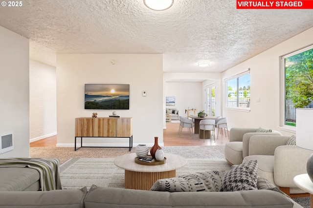 2380 NE Rene Ave, Gresham, OR 97030 - living area featuring a textured ceiling, heating unit, and wood finished floors
