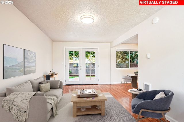 2380 NE Rene Ave, Gresham, OR 97030 - living room with wood finished floors, a textured ceiling, plenty of natural light, and french doors