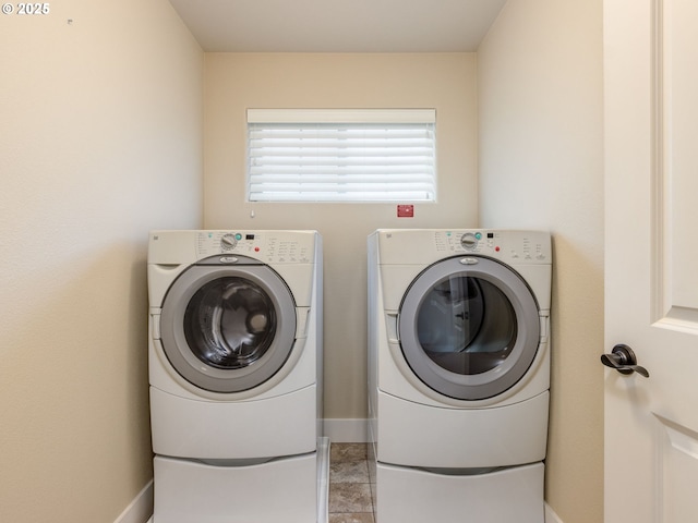 14420 SW Equestrian Ln, Beaverton, OR 97008 - washroom with washer and clothes dryer and baseboards