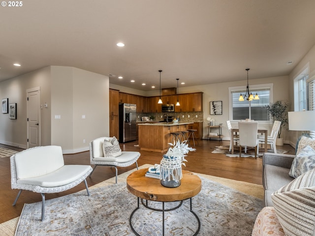 14420 SW Equestrian Ln, Beaverton, OR 97008 - living area featuring a chandelier, dark wood-type flooring, baseboards, and recessed lighting
