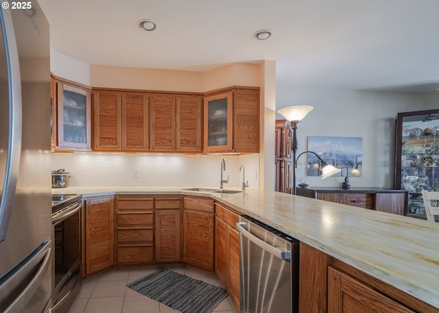 1 3rd St, Astoria, OR 97103 - kitchen featuring stainless steel appliances, brown cabinetry, tasteful backsplash, and recessed lighting