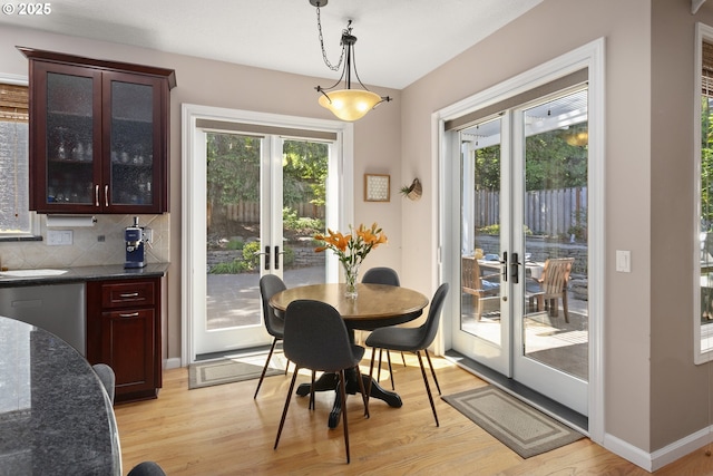 12453 SW Sheldrake Way, Beaverton, OR 97007 - dining area featuring french doors, light wood finished floors, and baseboards