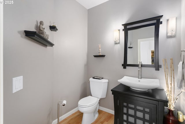 12453 SW Sheldrake Way, Beaverton, OR 97007 - bathroom featuring wood finished floors, toilet, vanity, and baseboards
