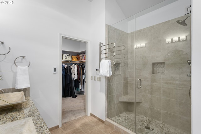 12453 SW Sheldrake Way, Beaverton, OR 97007 - full bathroom featuring a shower stall, a spacious closet, baseboards, and vanity