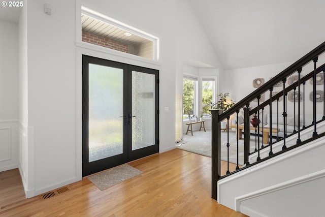 12453 SW Sheldrake Way, Beaverton, OR 97007 - entryway featuring french doors, stairs, light wood-style floors, and high vaulted ceiling