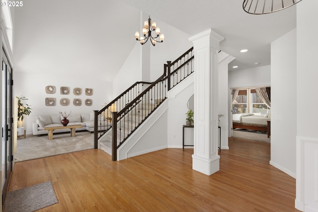 12453 SW Sheldrake Way, Beaverton, OR 97007 - foyer entrance featuring ornate columns, light wood-type flooring, stairs, baseboards, and recessed lighting