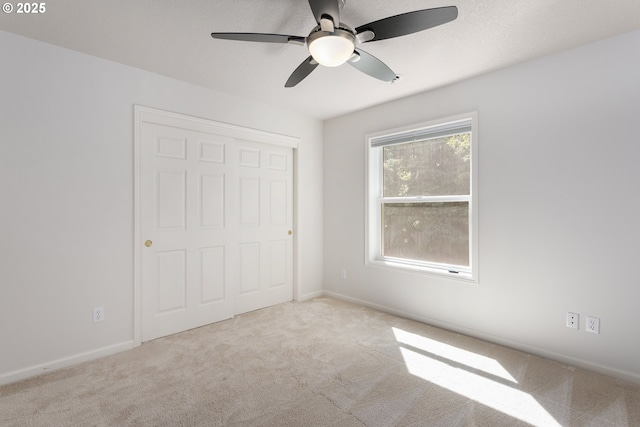 12453 SW Sheldrake Way, Beaverton, OR 97007 - unfurnished bedroom featuring light carpet, a closet, baseboards, a ceiling fan, and a textured ceiling