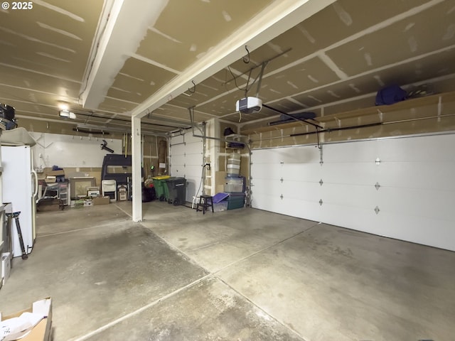 12453 SW Sheldrake Way, Beaverton, OR 97007 - garage with a garage door opener and freestanding refrigerator