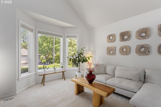 12453 SW Sheldrake Way, Beaverton, OR 97007 - living room featuring light colored carpet, healthy amount of natural light, baseboards, and lofted ceiling