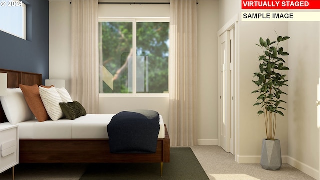 carpeted bedroom featuring multiple windows and baseboards