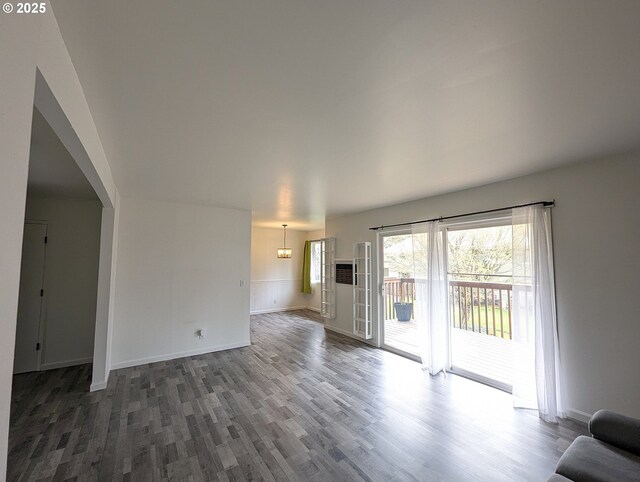 13155 SW Allen Blvd Unit 11, Beaverton, OR 97005 - unfurnished living room with arched walkways, wood finished floors, and a chandelier