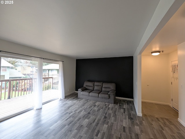 13155 SW Allen Blvd Unit 11, Beaverton, OR 97005 - living area with baseboards, an accent wall, and wood finished floors