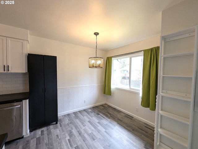 13155 SW Allen Blvd Unit 11, Beaverton, OR 97005 - unfurnished dining area featuring a wainscoted wall, a chandelier, and light wood-type flooring