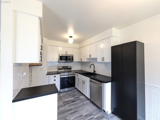 13155 SW Allen Blvd Unit 11, Beaverton, OR 97005 - kitchen with decorative backsplash, white cabinets, stainless steel appliances, dark countertops, and a sink