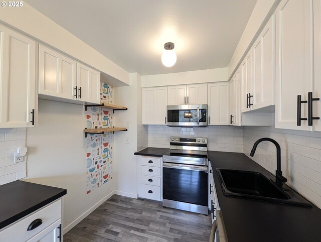 13155 SW Allen Blvd Unit 11, Beaverton, OR 97005 - kitchen featuring dark countertops, appliances with stainless steel finishes, white cabinetry, a sink, and open shelves