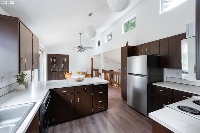 kitchen featuring dark brown cabinets, hanging light fixtures, ceiling fan, stainless steel fridge, and dark hardwood / wood-style flooring