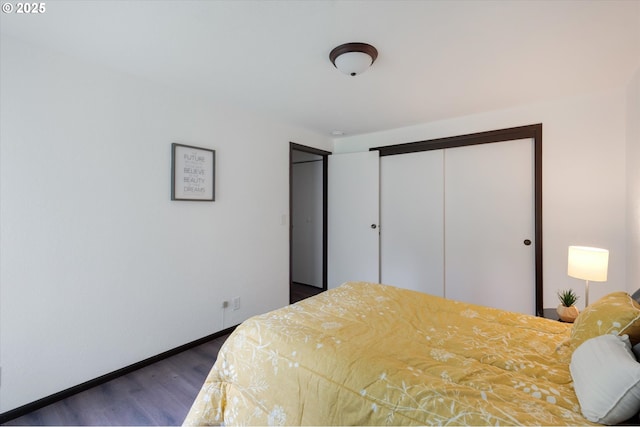 bedroom with a closet and dark hardwood / wood-style flooring