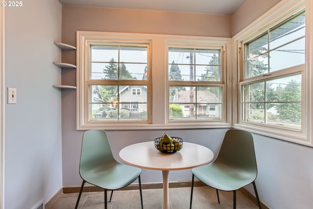dining space featuring baseboards