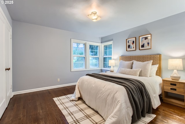 bedroom featuring wood finished floors and baseboards