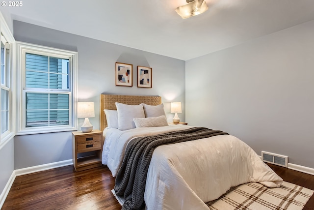 bedroom featuring baseboards and wood finished floors