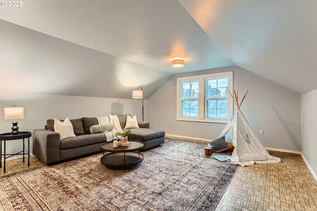 living room with vaulted ceiling and baseboards