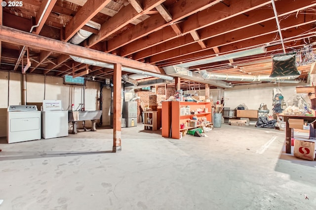 unfinished basement with washer and dryer, a sink, and heating unit