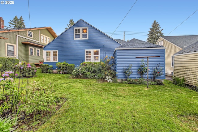 rear view of house featuring a lawn