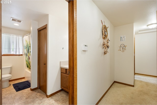 hallway featuring baseboards