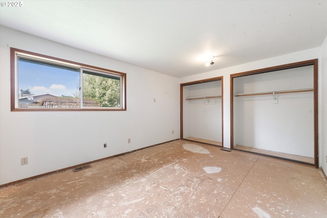 2509 E J Ct, La Grande, OR 97850 - unfurnished bedroom featuring baseboards, multiple closets, and visible vents