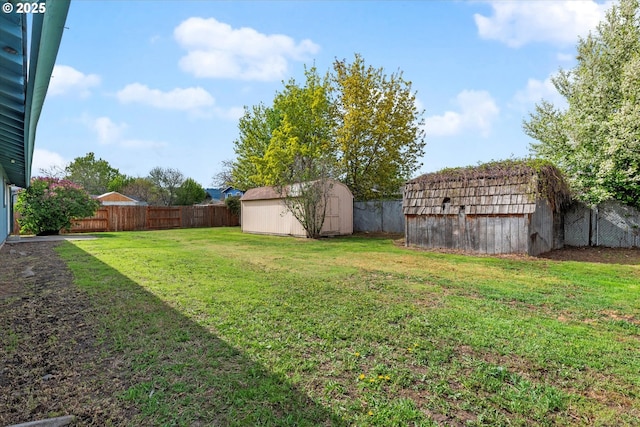 2509 E J Ct, La Grande, OR 97850 - view of yard featuring an outbuilding, a fenced backyard, and a storage unit