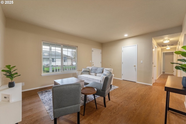 living room with visible vents, recessed lighting, baseboards, and wood finished floors