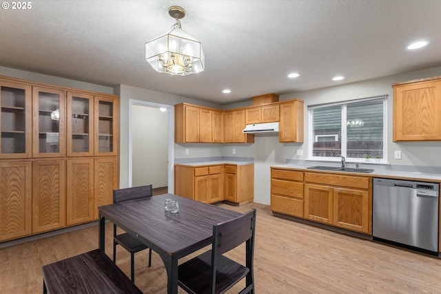 kitchen featuring under cabinet range hood, dishwasher, light wood-type flooring, recessed lighting, and a sink