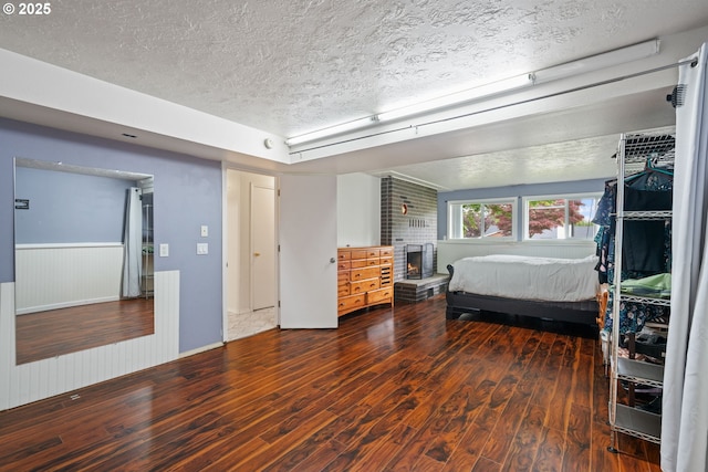 790 SE Robin Way, Gresham, OR 97080 - bedroom featuring a textured ceiling, wood finished floors, and a wainscoted wall