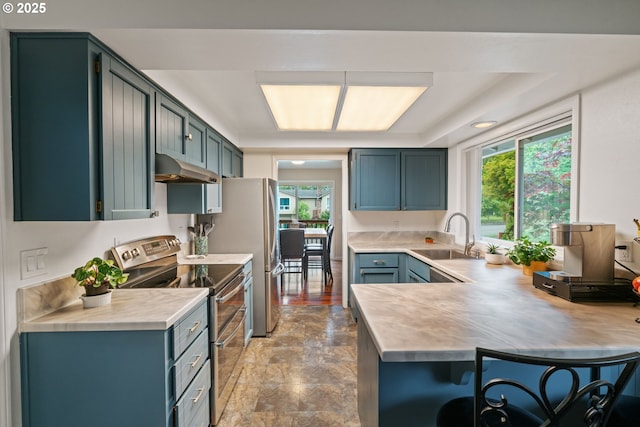790 SE Robin Way, Gresham, OR 97080 - kitchen featuring stainless steel appliances, a sink, under cabinet range hood, light countertops, and a peninsula