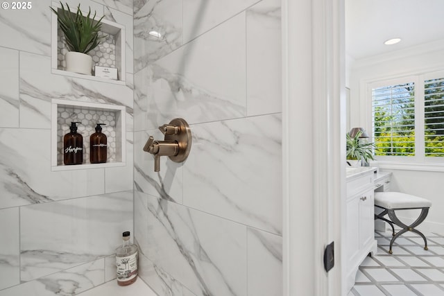 full bath with vanity, a marble finish shower, and crown molding