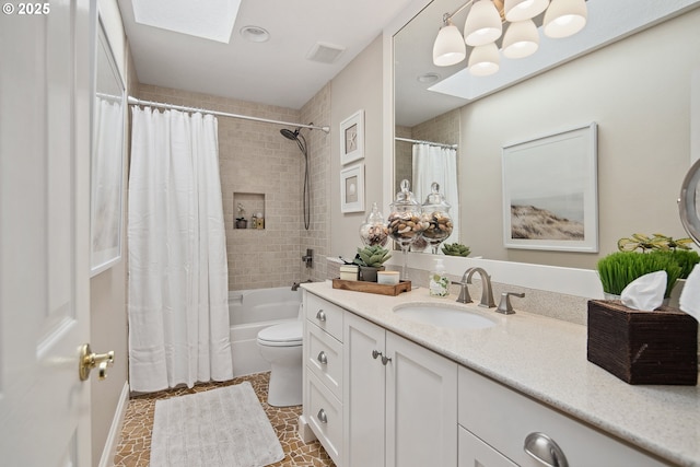 full bath featuring visible vents, toilet, vanity, a skylight, and shower / tub combo