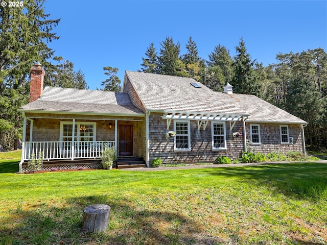 ranch-style house featuring a porch, a front lawn, and a chimney
