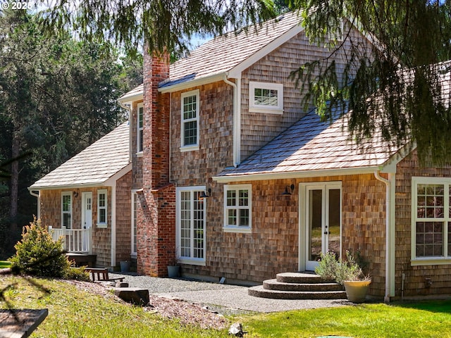 exterior space with french doors and a chimney