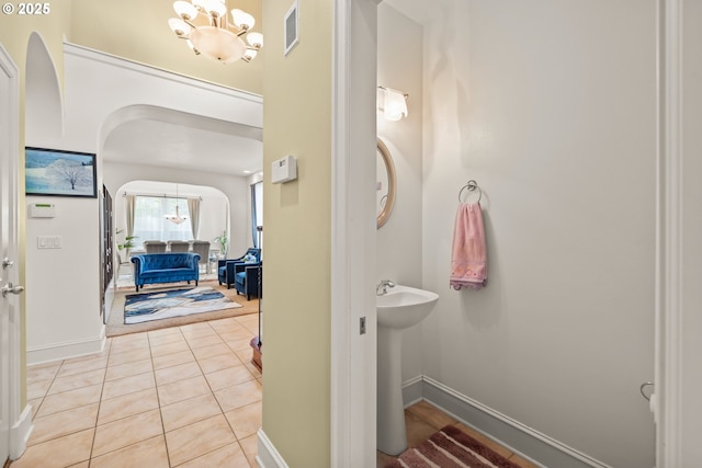 12696 NW Alsace Ln, Portland, OR 97229 - bathroom with a chandelier, baseboards, and tile patterned flooring