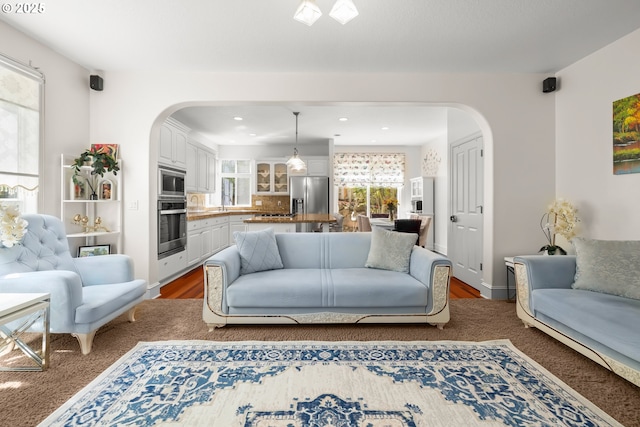 12696 NW Alsace Ln, Portland, OR 97229 - living room featuring arched walkways, recessed lighting, and wood finished floors