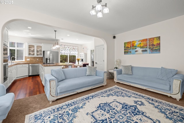 12696 NW Alsace Ln, Portland, OR 97229 - living area with arched walkways, plenty of natural light, recessed lighting, and dark wood-style flooring