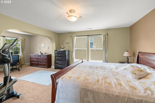 12696 NW Alsace Ln, Portland, OR 97229 - carpeted bedroom with arched walkways and a textured ceiling