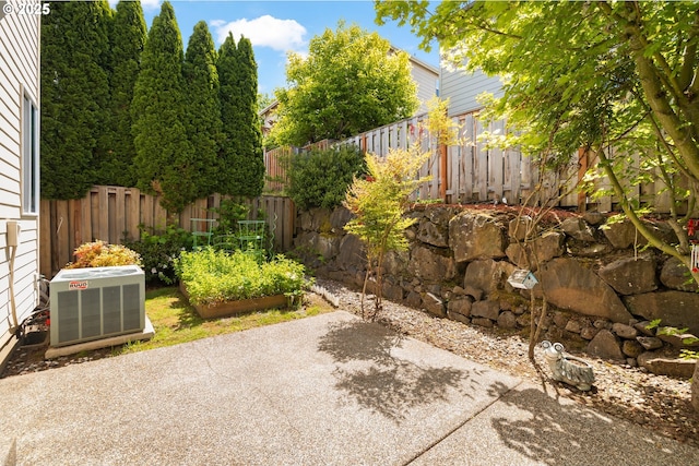 12696 NW Alsace Ln, Portland, OR 97229 - fenced backyard featuring cooling unit, a patio area, and a vegetable garden